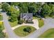 Aerial view of a landscaped home featuring manicured lawns, mature trees, and a circular driveway at 801 Windsor Rdg, Canton, GA 30115