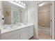 Bathroom featuring double sinks, a large mirror, white cabinets, and a shower-tub combination at 801 Windsor Rdg, Canton, GA 30115