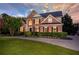 Charming two-story brick home with manicured lawn, elegant landscaping, and a circular driveway at 801 Windsor Rdg, Canton, GA 30115