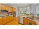 Bright kitchen with wooden cabinets, stainless steel appliances, a bay window, and hardwood floors at 801 Windsor Rdg, Canton, GA 30115