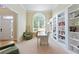 Well-lit home office with built-in bookshelves, large arched window, and neutral decor at 801 Windsor Rdg, Canton, GA 30115