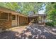 Backyard brick patio, screened porch and lush surrounding landscape at 1646 Rainier Falls Ne Dr, Atlanta, GA 30329