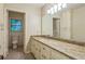 Bright bathroom featuring a granite vanity, large mirror, vanity lighting, and tiled floors at 1646 Rainier Falls Ne Dr, Atlanta, GA 30329