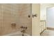 Bathroom alcove showcasing tiled walls, a bathtub, and a view into a vanity area at 1646 Rainier Falls Ne Dr, Atlanta, GA 30329