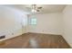 Clean bedroom with hardwood floors, ceiling fan, fresh paint, and a window bringing in natural light at 1646 Rainier Falls Ne Dr, Atlanta, GA 30329