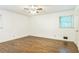 Spacious bedroom with hardwood floors, fresh paint, ceiling fan, and a window bringing in natural light at 1646 Rainier Falls Ne Dr, Atlanta, GA 30329