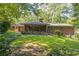 Back of home with brick and lush landscape at 1646 Rainier Falls Ne Dr, Atlanta, GA 30329