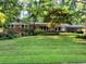 Charming single Gathering home with brick accents, a well-manicured lawn, and a covered carport at 1646 Rainier Falls Ne Dr, Atlanta, GA 30329