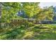 Charming single Gathering home with brick accents, a well-manicured lawn, and mature landscaping at 1646 Rainier Falls Ne Dr, Atlanta, GA 30329