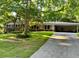 Charming single Gathering home with brick accents, a well-manicured lawn, and a long driveway at 1646 Rainier Falls Ne Dr, Atlanta, GA 30329