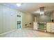Cozy kitchen featuring stainless steel appliances and granite countertops, adjacent to a carpeted dining area at 1646 Rainier Falls Ne Dr, Atlanta, GA 30329