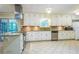 Bright kitchen with white cabinetry, granite countertops, stainless steel appliances, and tile flooring at 1646 Rainier Falls Ne Dr, Atlanta, GA 30329
