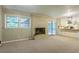 Open living area with fireplace, sliding glass doors to the screened in porch, and a pass through to the kitchen at 1646 Rainier Falls Ne Dr, Atlanta, GA 30329