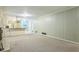 Spacious living room with neutral carpet, paneled walls, brick fireplace and open floor plan at 1646 Rainier Falls Ne Dr, Atlanta, GA 30329