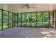 Enclosed porch featuring ceiling fan, and views of a serene wooded backyard, perfect for outdoor entertaining at 1646 Rainier Falls Ne Dr, Atlanta, GA 30329