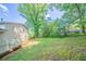 Spacious backyard with lush greenery and mature trees surrounding the home at 1658 Pine Glen Cir, Decatur, GA 30035