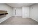 A finished basement with neutral walls, carpeted floor, and a wooden storage shelf at 1658 Pine Glen Cir, Decatur, GA 30035
