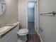 Modern bathroom with a granite countertop, oval mirror, and wood-look flooring at 1658 Pine Glen Cir, Decatur, GA 30035