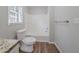 Bright bathroom with a shower-tub combination and new wood-style flooring at 1658 Pine Glen Cir, Decatur, GA 30035