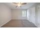 Bedroom features neutral paint, carpeted floors, a ceiling fan, and a window with an exterior view at 1658 Pine Glen Cir, Decatur, GA 30035