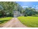 Charming two-story home with a well-manicured front lawn and a paved driveway leading to an attached garage at 1658 Pine Glen Cir, Decatur, GA 30035