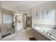 Bright bathroom showcasing a glass-enclosed shower and a luxurious soaking tub at 1691 Holcomb Lake Rd, Marietta, GA 30062