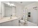 ' bathroom with dinosaur-themed shower curtain, white fixtures, and tile flooring at 1691 Holcomb Lake Rd, Marietta, GA 30062