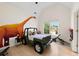 Unique bedroom with a dinosaur-themed mural, playful design, and large window at 1691 Holcomb Lake Rd, Marietta, GA 30062