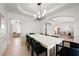 Open-concept dining area with tray ceiling and modern light fixture at 1691 Holcomb Lake Rd, Marietta, GA 30062