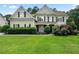 Charming two-story home with manicured lawn and lush landscaping at 1691 Holcomb Lake Rd, Marietta, GA 30062