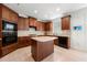 Well-equipped kitchen with dark wood cabinets, an island, and stainless appliances at 1691 Holcomb Lake Rd, Marietta, GA 30062