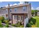 Aerial view of townhouse backyards featuring patios, pergolas, and green spaces at 176 Oak Green Dr, Lawrenceville, GA 30044