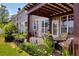 Backyard featuring patio, pergola, flower beds, and wooden fence at 176 Oak Green Dr, Lawrenceville, GA 30044