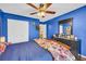 Blue bedroom featuring a double door closet, wood floors, and vintage décor at 176 Oak Green Dr, Lawrenceville, GA 30044