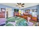 Bright bedroom featuring wood furniture, ceiling fan and closet access at 176 Oak Green Dr, Lawrenceville, GA 30044