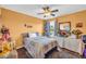 Sun-lit bedroom featuring wood floors, neutral tones, and a ceiling fan at 176 Oak Green Dr, Lawrenceville, GA 30044