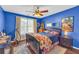 Bright bedroom featuring blue walls, hardwood floors and natural lighting at 176 Oak Green Dr, Lawrenceville, GA 30044