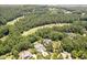 Aerial view of an estate home situated on a wooded lot near the golf course and luxury homes at 4317 Oglethorpe Nw Loop, Acworth, GA 30101