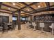 Basement bar area with wood plank ceiling, dark wood bar, stone accent wall, and multiple TVs at 4317 Oglethorpe Nw Loop, Acworth, GA 30101
