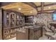 Stylish basement bar featuring custom shelving, a marble countertop, and seating for entertaining at 4317 Oglethorpe Nw Loop, Acworth, GA 30101