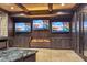 Basement entertainment area featuring an electric fireplace and three flat-screen TVs at 4317 Oglethorpe Nw Loop, Acworth, GA 30101