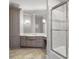 Modern bathroom with neutral colored cabinets, stone countertops, and a glass door to the shower at 4317 Oglethorpe Nw Loop, Acworth, GA 30101