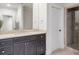 Bathroom features a modern vanity with stone countertops, dark wood cabinets, and a glass-enclosed shower at 4317 Oglethorpe Nw Loop, Acworth, GA 30101