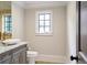 This powder room features a marble vanity, vessel sink, modern fixtures, and a window at 4317 Oglethorpe Nw Loop, Acworth, GA 30101
