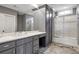 This bathroom features a white marble countertop, grey cabinets, and a glass enclosed shower at 4317 Oglethorpe Nw Loop, Acworth, GA 30101