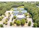 Aerial view of a well-maintained community clubhouse with tennis courts, pool, and ample parking at 4317 Oglethorpe Nw Loop, Acworth, GA 30101