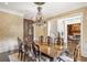Elegant dining room with a large table, decorative chandelier, and view into the home office at 4317 Oglethorpe Nw Loop, Acworth, GA 30101