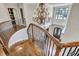 A foyer featuring dark hardwood stairs, wood railing, and a large chandelier at 4317 Oglethorpe Nw Loop, Acworth, GA 30101