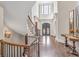 Grand foyer features curved staircase, hardwood floors, double front doors, and tall windows at 4317 Oglethorpe Nw Loop, Acworth, GA 30101