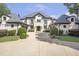 Grand home with manicured landscaping featuring a stately stone and stucco exterior, and a gray shingled roof at 4317 Oglethorpe Nw Loop, Acworth, GA 30101